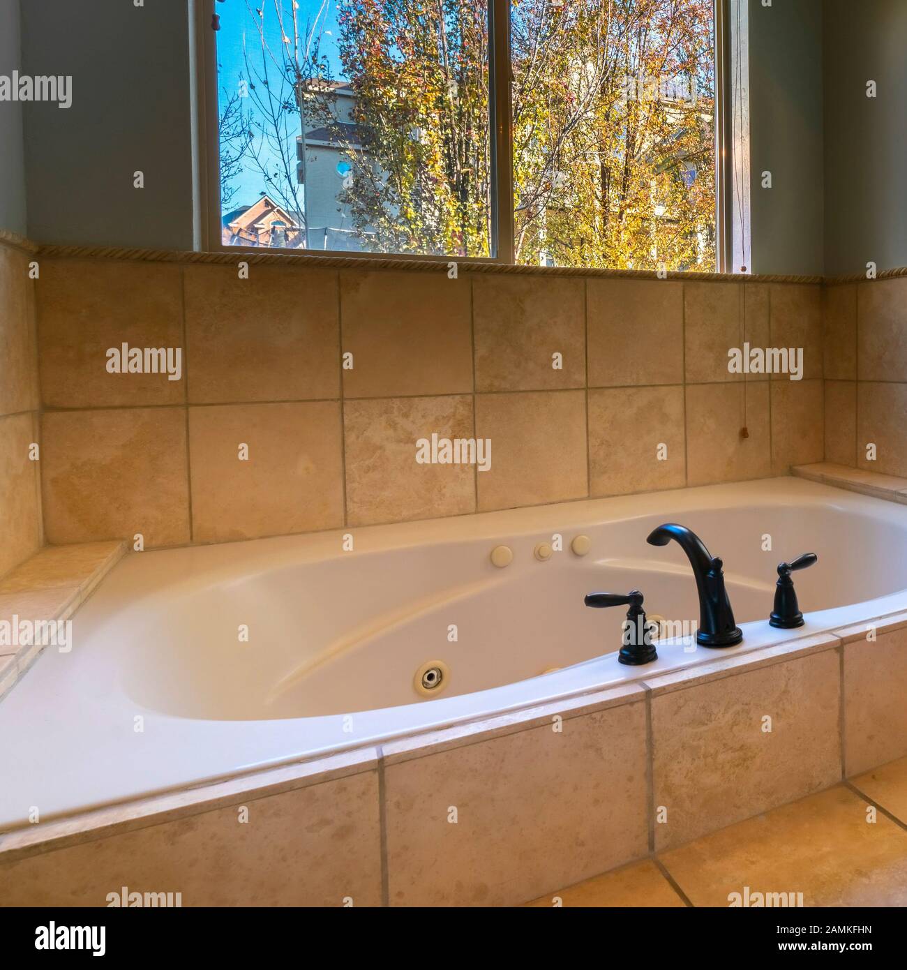 Square frame Luxury modern sunken bath with tiled surround Stock Photo