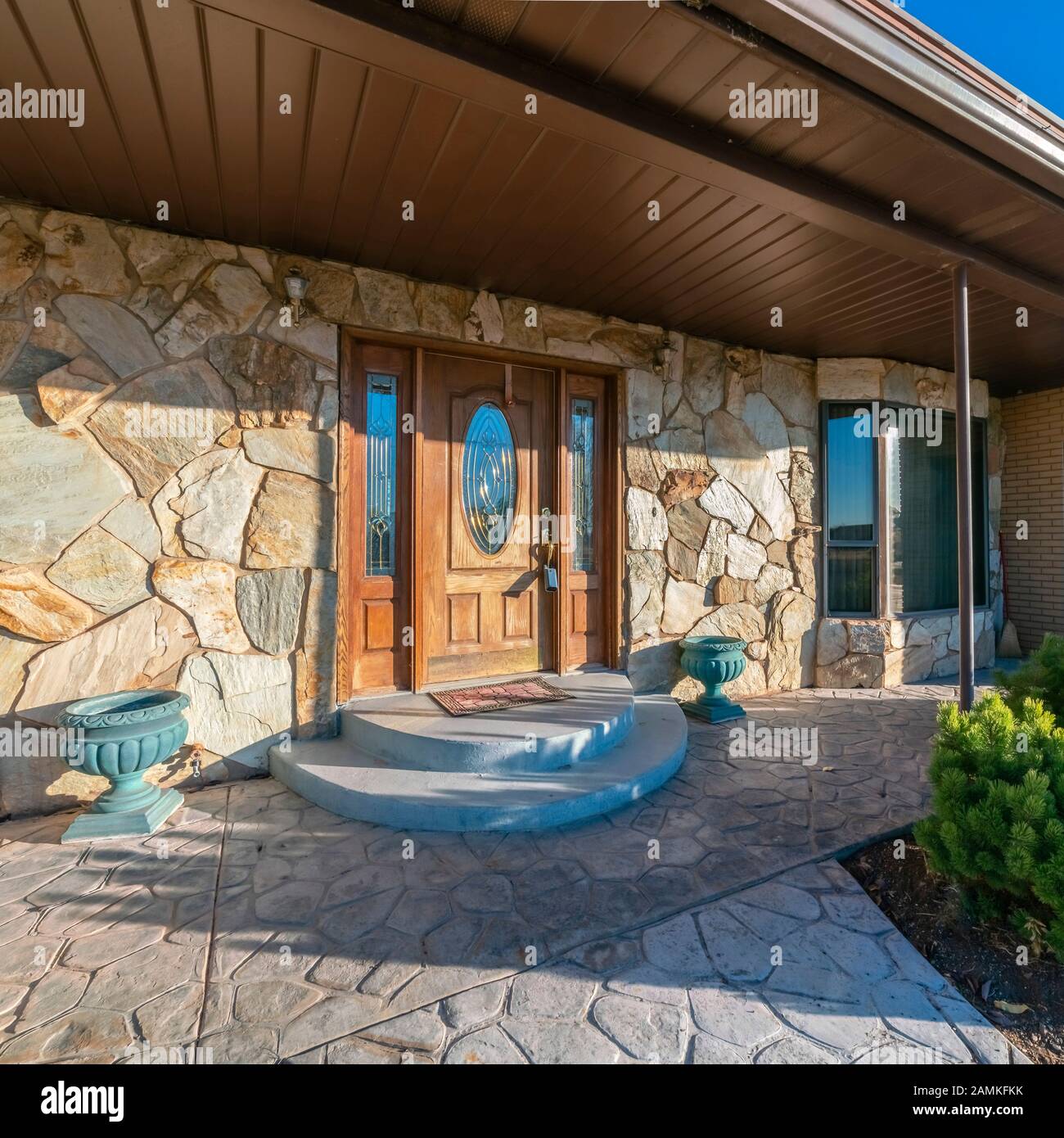 Square Modern house with paved patio and circular steps Stock Photo - Alamy