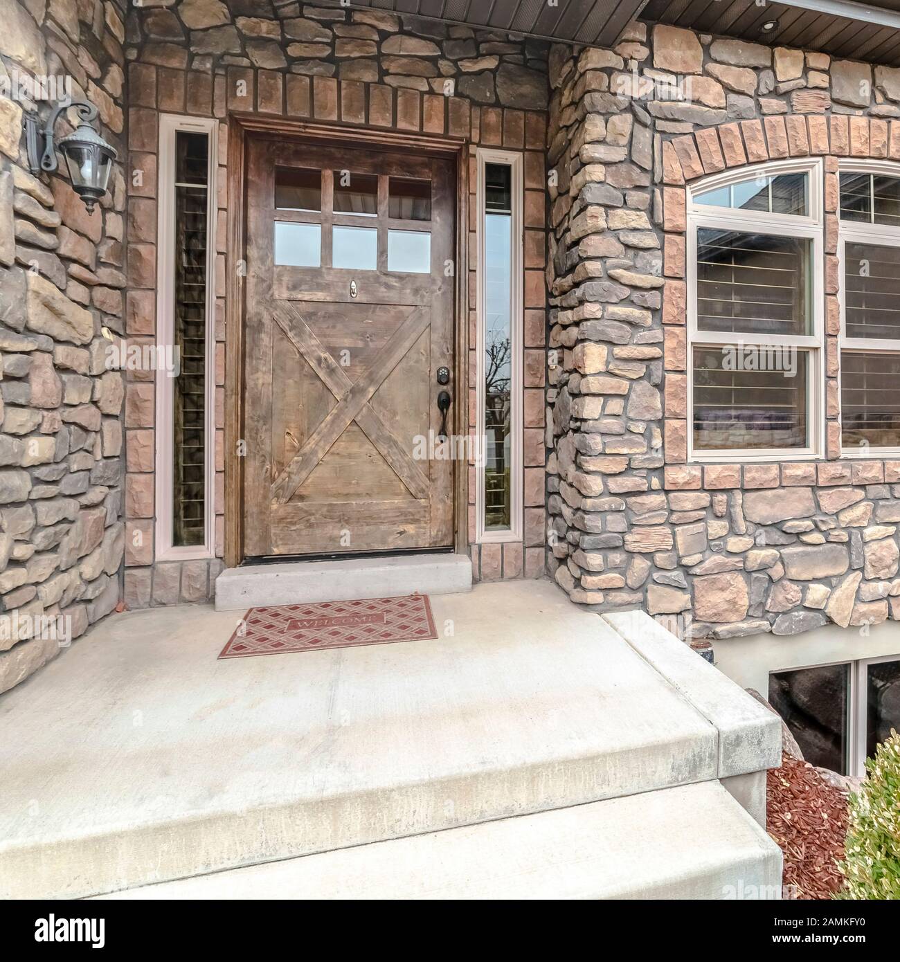 Square Modern house with feature stone wall day light Stock Photo - Alamy
