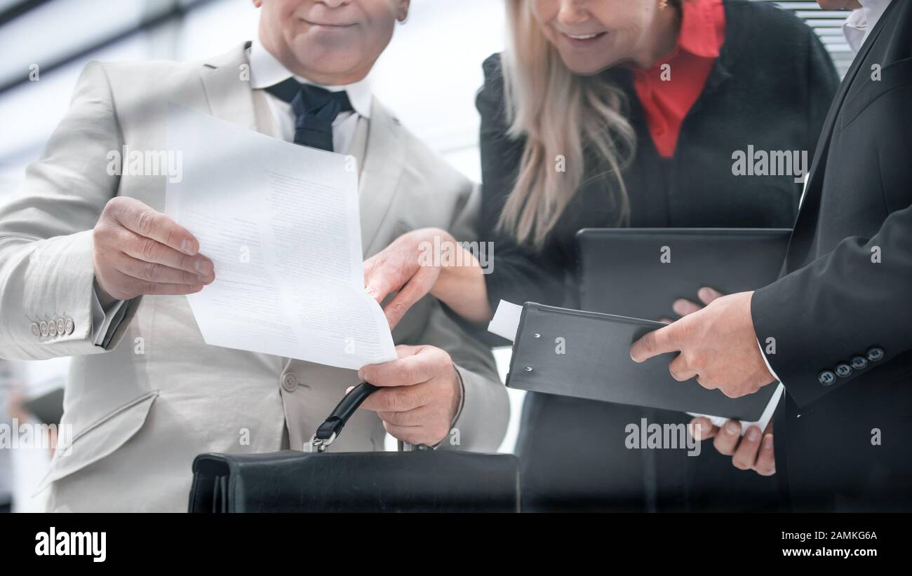 businesswoman discussing with colleagues and working papers Stock Photo