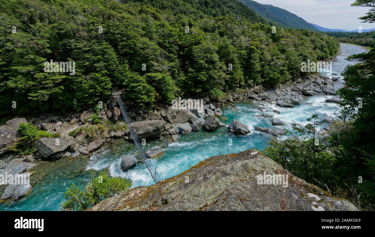 Scary high swing bridge over the Wairau River, Lees Creek hut walk, Nelson Lakes National Park area, New Zealand. Stock Photo