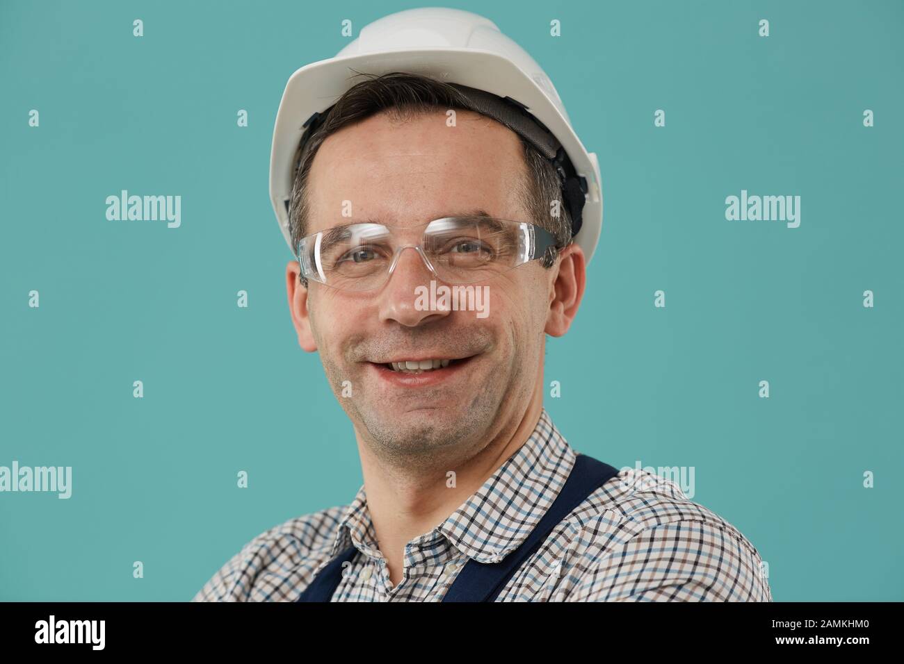 Head and shoulders portrait of professional worker or builder smiling