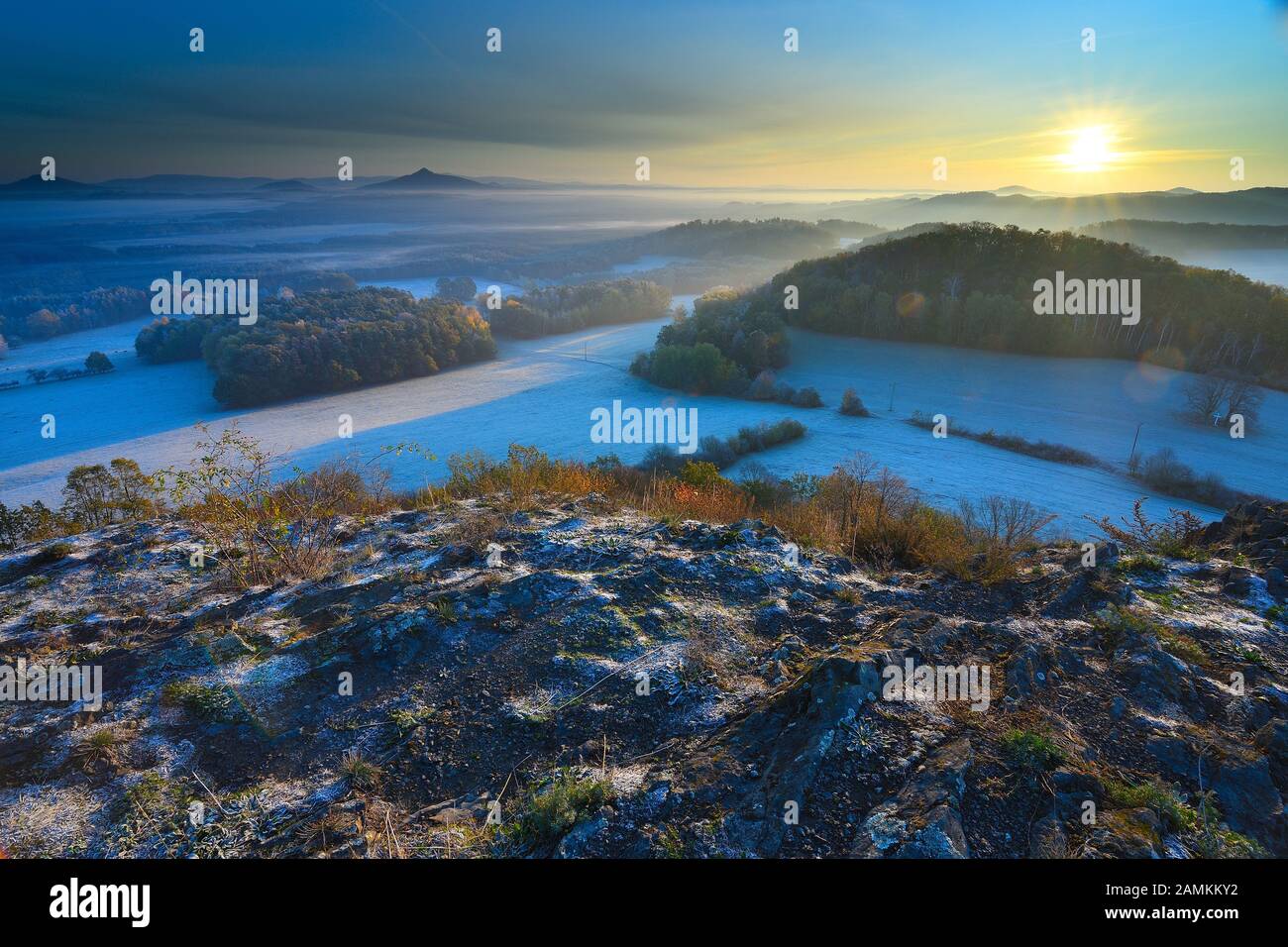 Picturesque colorful ridge of sunrise against the blue misty hills ...