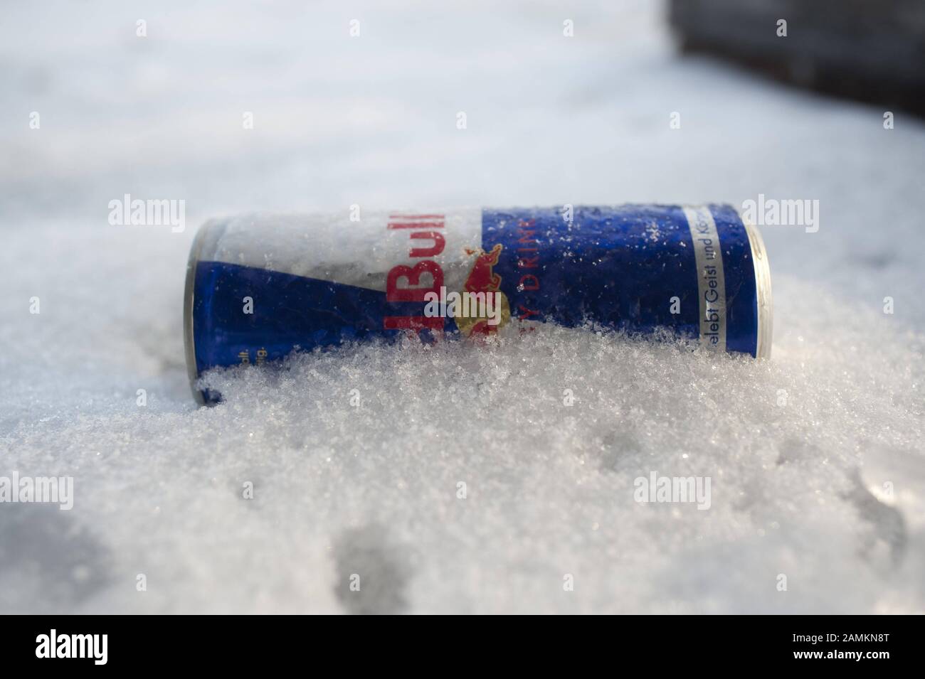 A Red Bull can lies in the snow, symbolic image of the Red Bull Crashed Ice Contest in Munich's Olympic Park [automated translation] Stock Photo