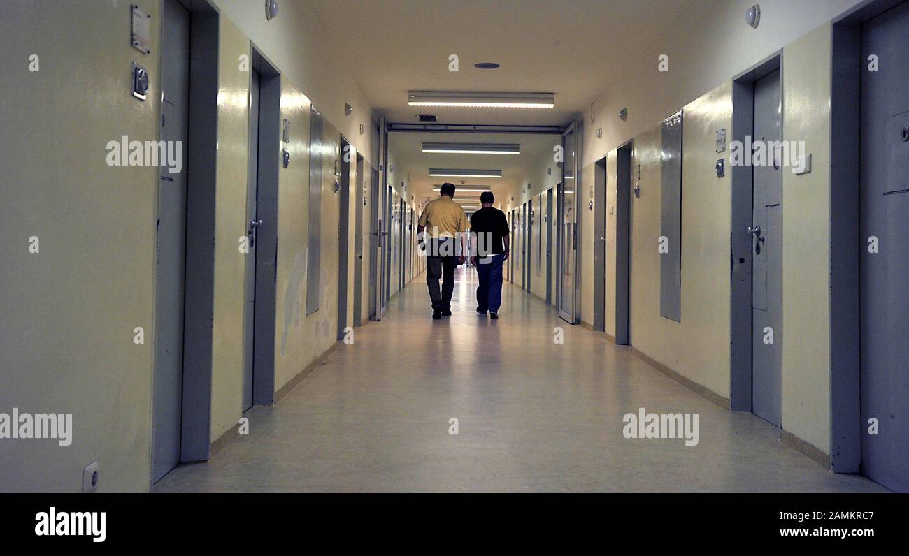Prison officer and prisoner in a corridor in the cell wing of