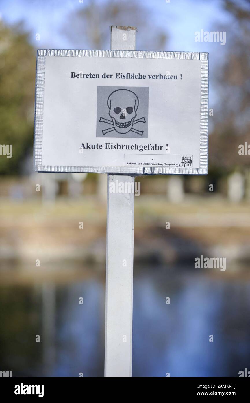 Warning sign with skull and crossbones and the inscription 'No trespassing on the ice rink. Acute danger of a broken egg!' at the Nymphenburger Kanal in Munich. There the winter sports programme is cancelled this year because the ice is not thick enough. [automated translation] Stock Photo
