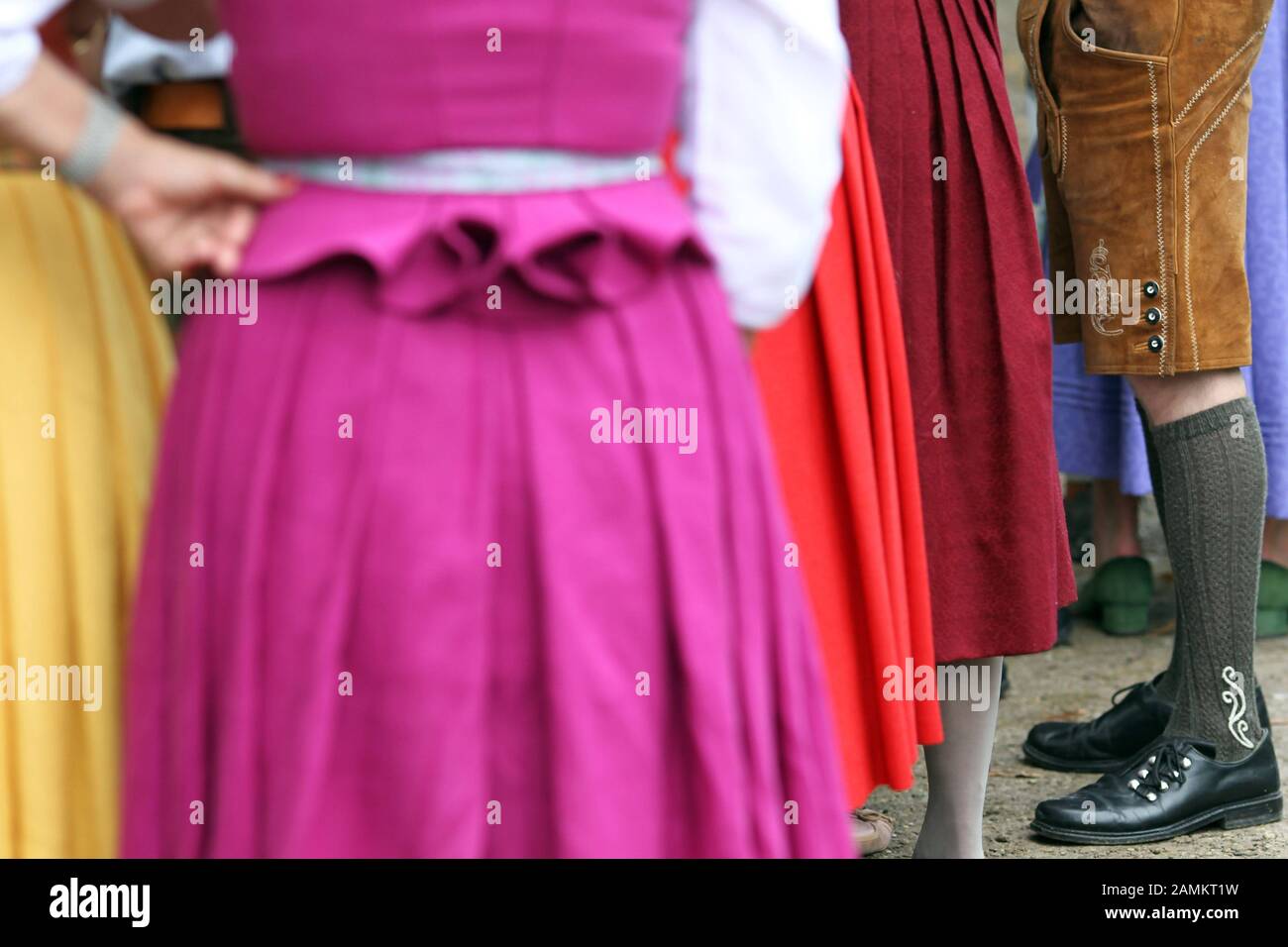 Picture detail on dirndl skirt and leather pants. [automated