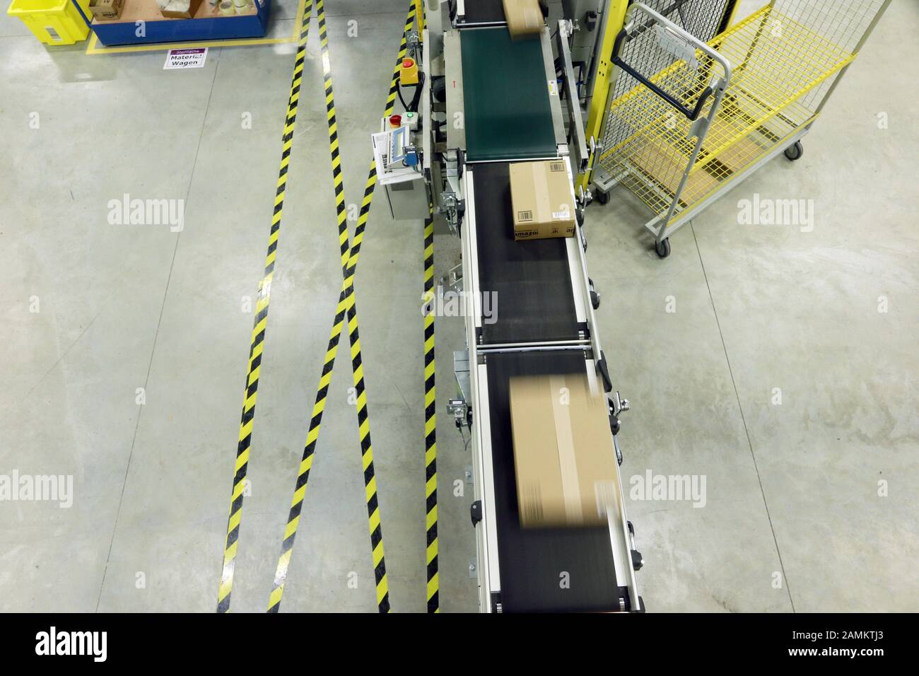 Conveyor belt with parcels in the Amazon logistics centre. [automated
