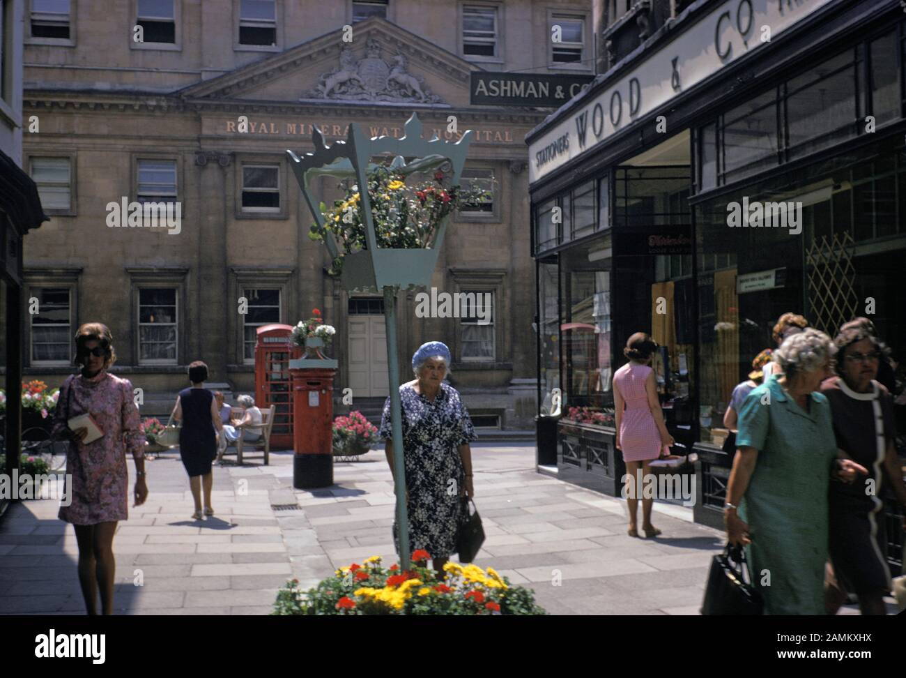 A 1970s street scene showing shoppers and pedestrians on the corner of Upper Borough Walls and Old Bond Street and the architecture of the Royal Mineral Water Hospital (now the Royal National Hospital of Rheumatic Deseseases), in central Bath, on 20th August 1971, in Bath, Somerset, England. Stock Photo