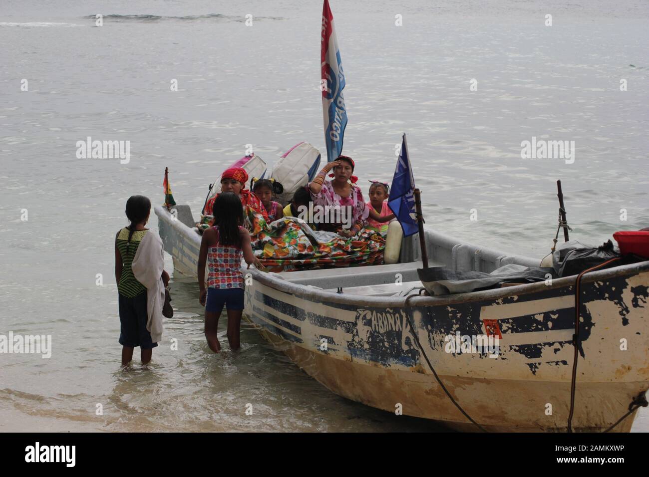 Women of the Kuna Indians in boat on the sandy beach of the San Blas