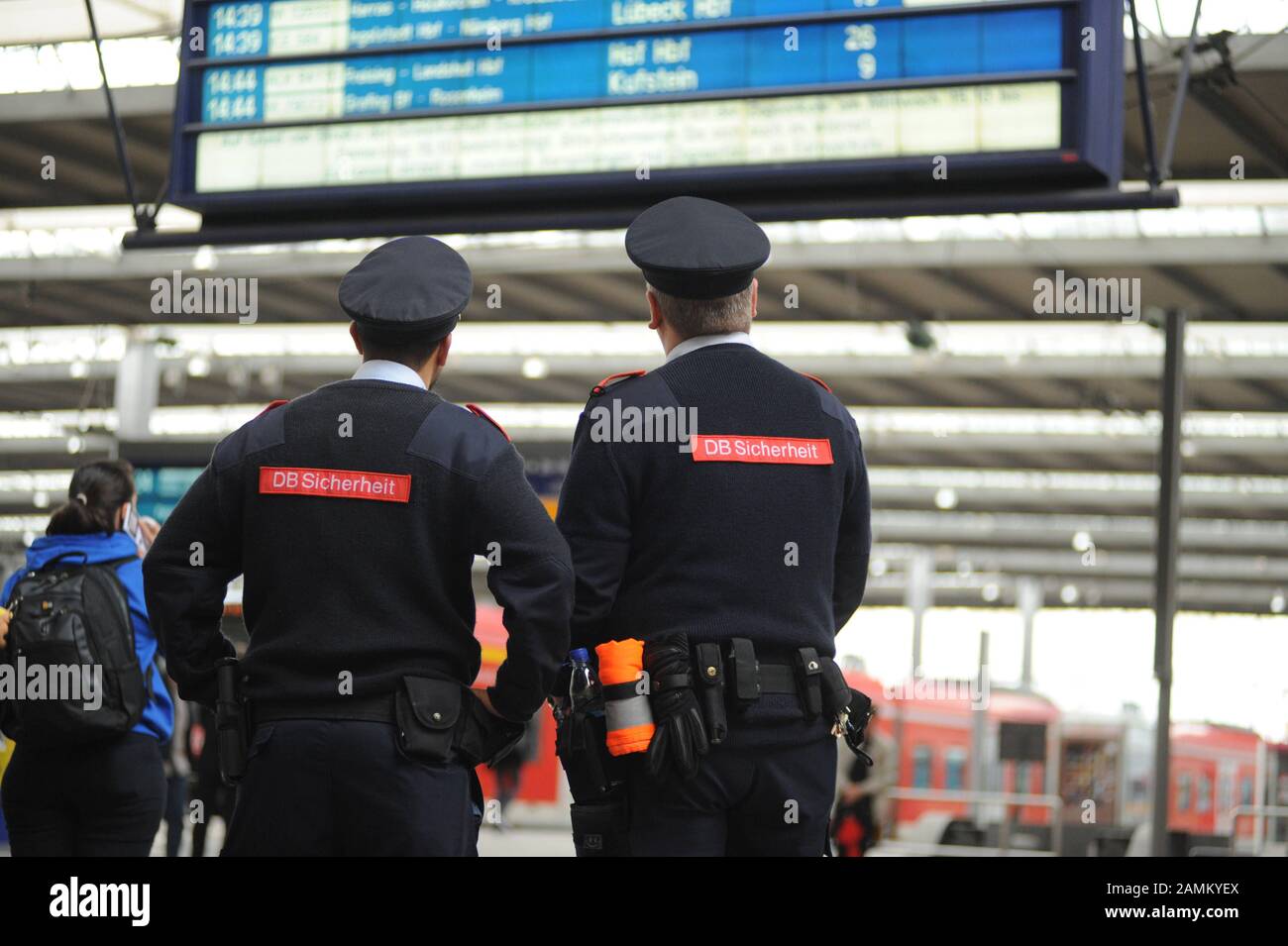 A strike by the train drivers' union GDL has paralyzed the S-Bahn and long-distance trains in Munich to a large extent. The picture shows two DB Sicherheit employees in front of a display board at the main station with train cancellations in the main station. [automated translation] Stock Photo