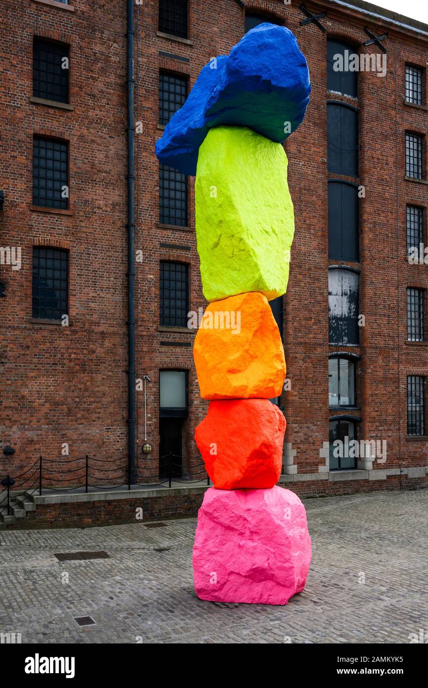'Liverpool Mountain' gravity-deying sculpture by Swiss artist Ugo Rondinone sits in Mermaid Courtyard outside the Tate Liverpool at Royal Albert Dock. Stock Photo