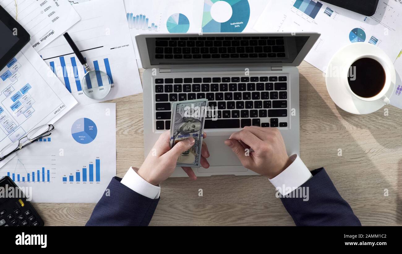 Business person counting money at the table, large income, success. Top ...