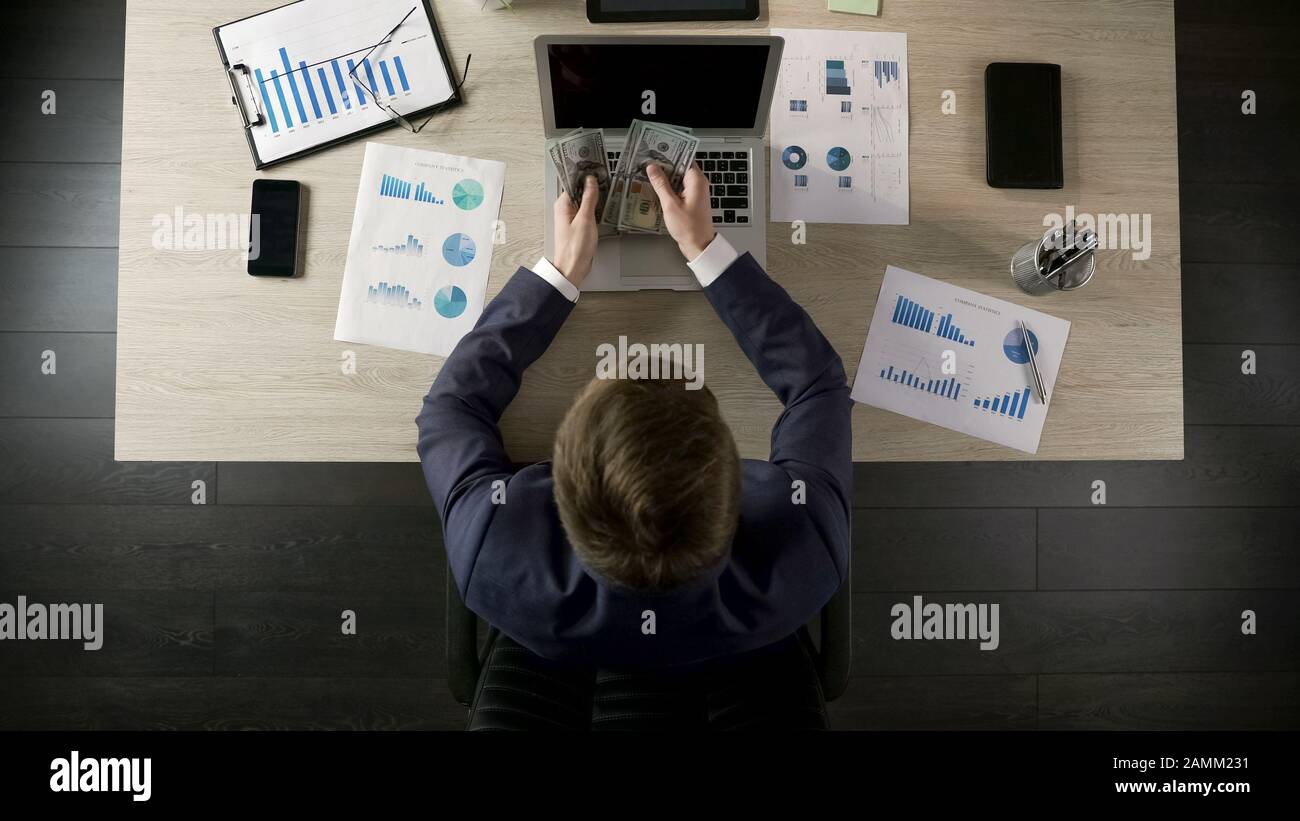 Successful businessman counting money, income from lucrative business, top view Stock Photo