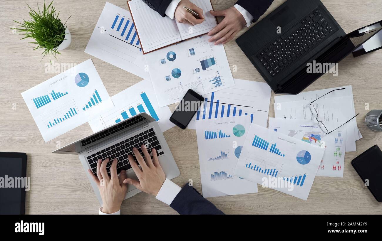 Analysts studying opinion poll statistics, preparing election campaign ...