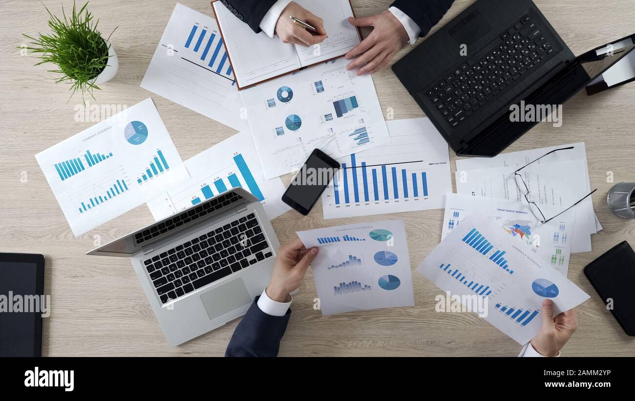 Analysts preparing notes to future on-line presentation learning statistics Stock Photo