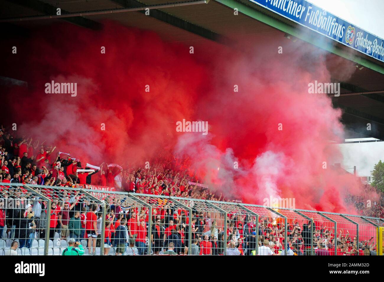 Derby in the southern regional football league: FC Bayern München II - TSV 1860 München II in the municipal stadium on Grünwalder Straße. The picture shows Bengalese fires in the block of the Bavarian fans on the counter tribune. [automated translation] Stock Photo