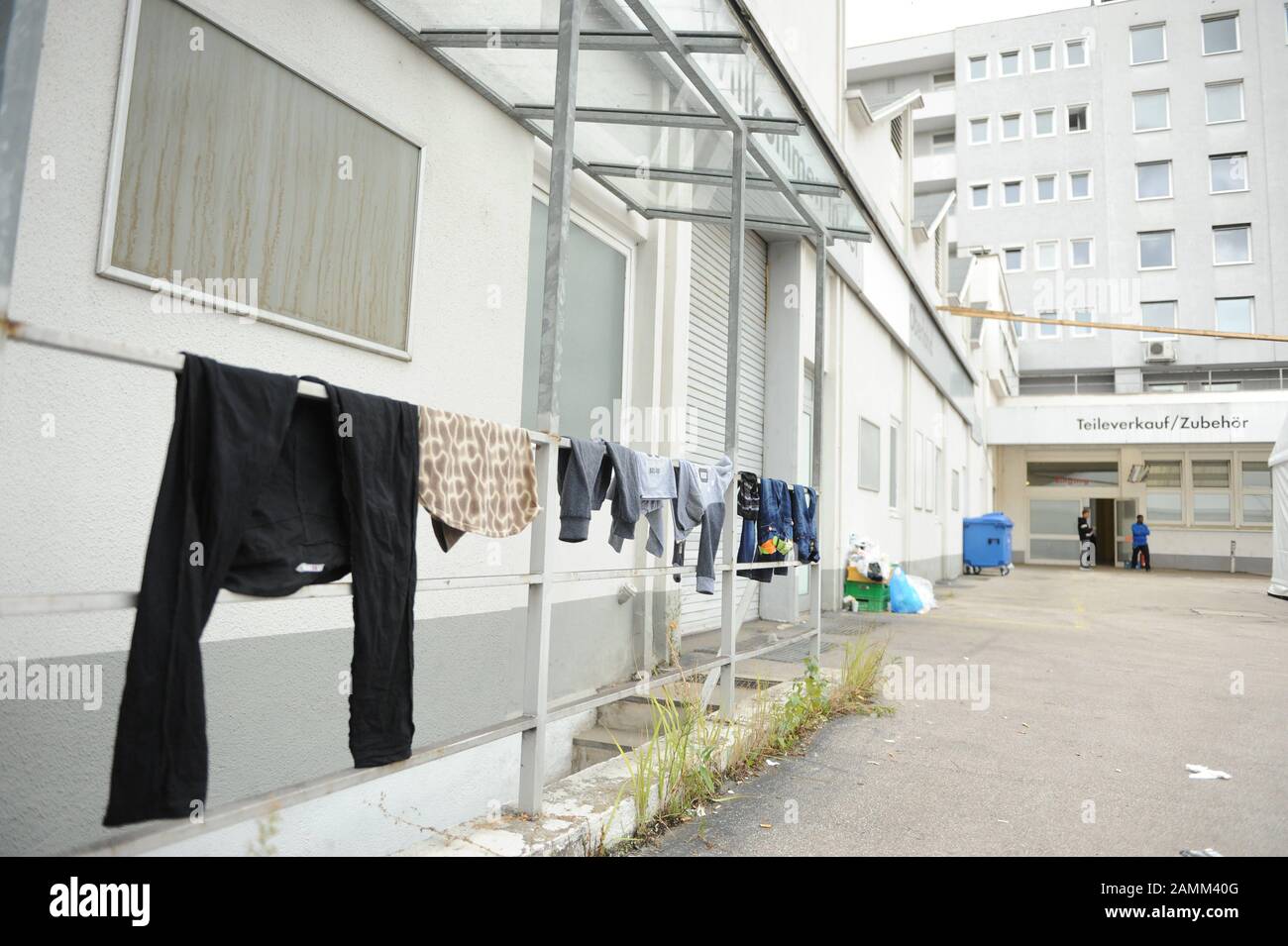 Improvised temporary shelter for refugees in the former Mahag Garage in Karlstraße: in the picture clothes are hanging to dry outside. [automated translation] Stock Photo