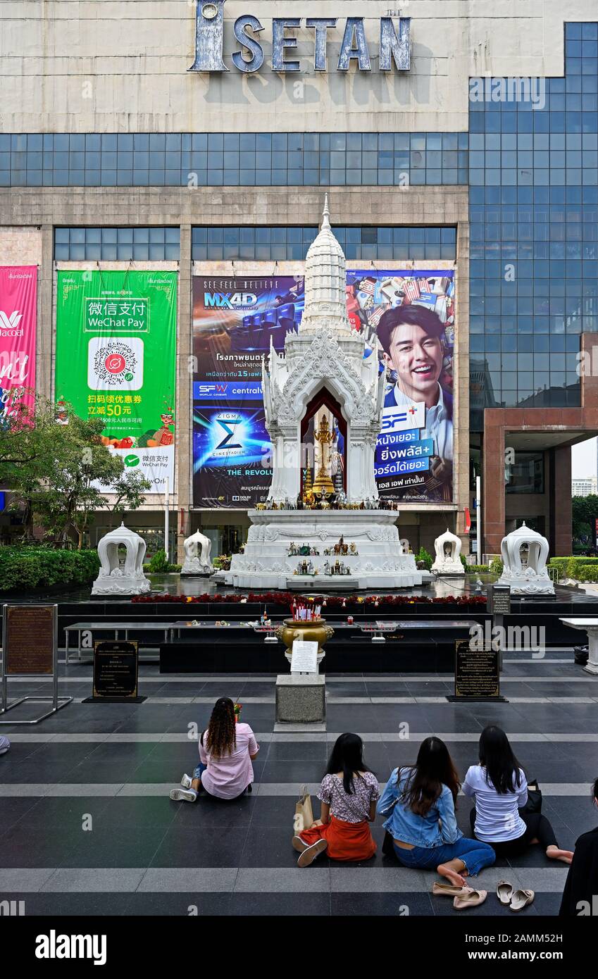 bangkok, thailand - 2020.01.12: trimurti shrine at ratchaprasong in front of central world shopping mall  / isetan department store Stock Photo