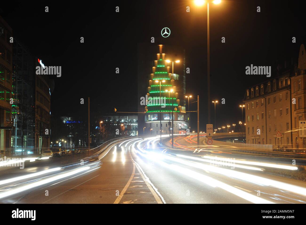 Nightly view of Landshuter Allee with the Christmas-lit high-rise building of the Mercedes Benz Center Munich branch in the background on the middle ring road. [automated translation] Stock Photo