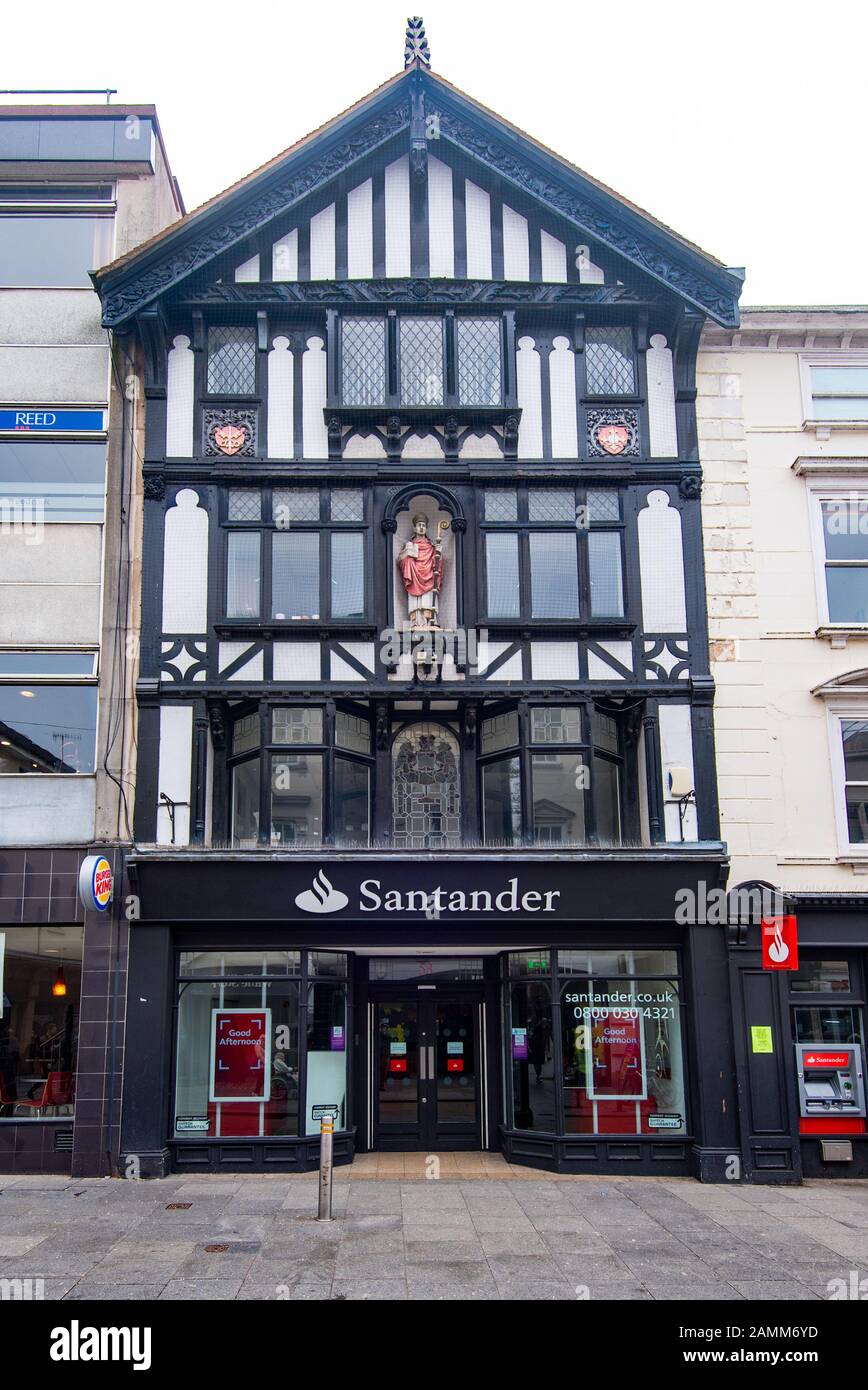 EXETER, DEVON, UK - 31MAR19: The Santander Bank is housed in an Elizabethan style building at 53 High Street. The statue in the facade is of Leofric. Stock Photo