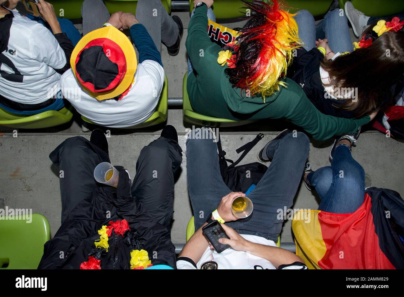 Football fans at the Public Viewing in the Olympic Stadium on the occasion of the quarter final match between Germany and Italy during the European Football Championship 2016. [automated translation] Stock Photo