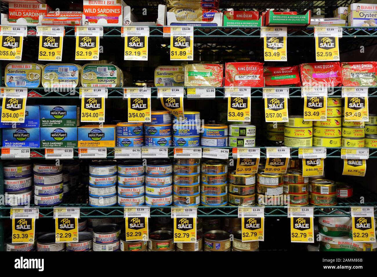 Different brands and varieties of canned tuna, and sardines at a supermarket Stock Photo