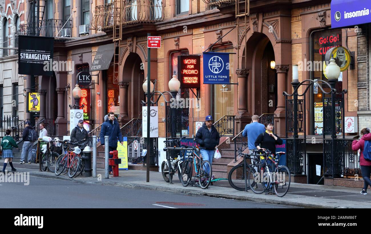 People walking past restaurants and eateries on East 53rd St btwn Third and Lexington Aves' in Midtown Manhattan in New York, NY. (January 11, 2020) Stock Photo