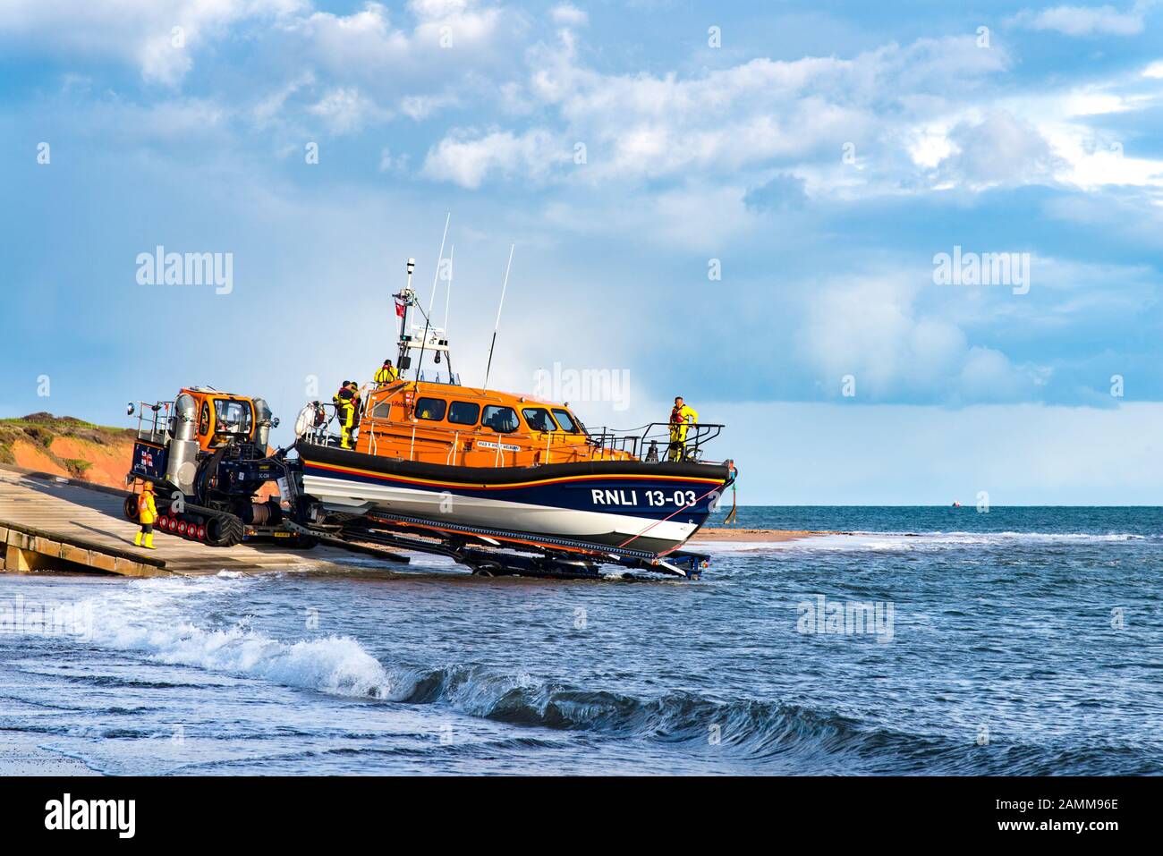 EXMOUTH, DEVON, UK - 3APR2019: RNLB R & J Welburn, a Shannon Class lifeboat, being lowered down the slipway by tractor, during a regular exercise. Stock Photo