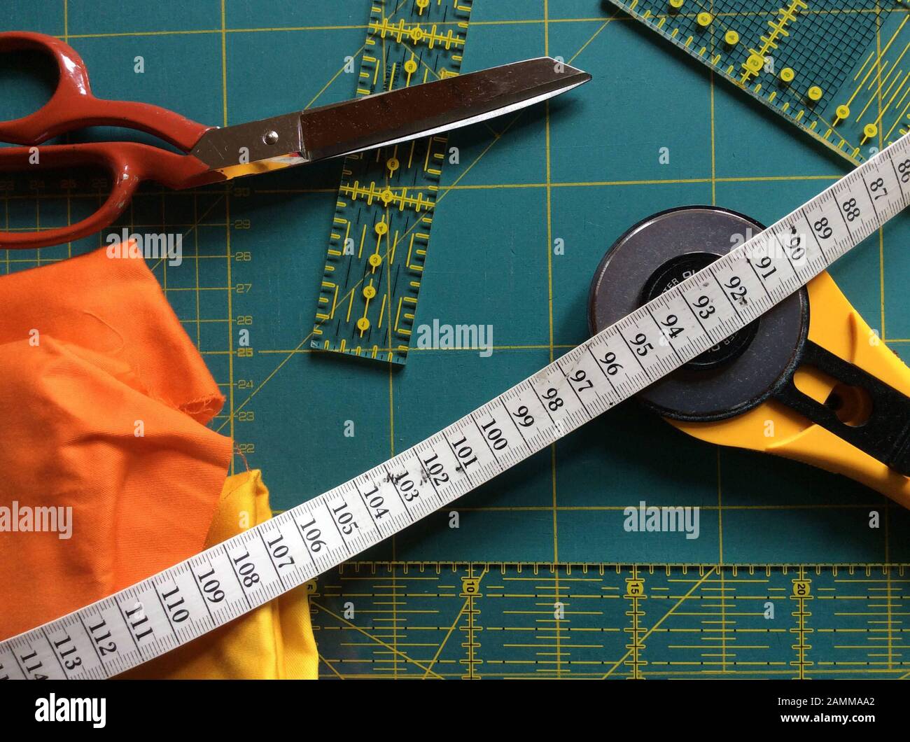 various tools in a quilt studio, cutting mat, scissors, measuring tape