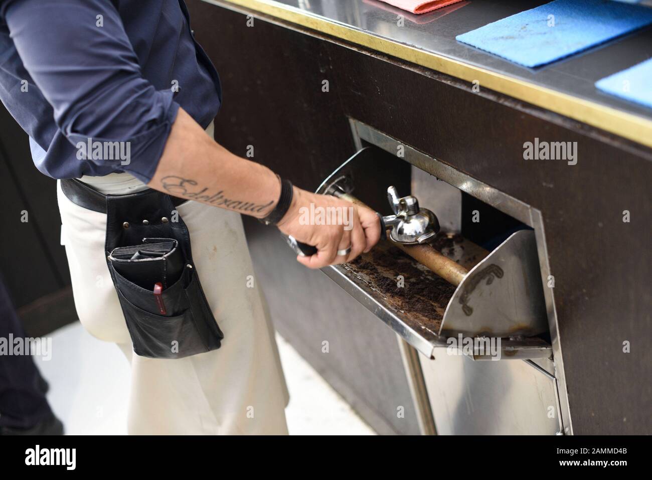 An employee empties the used espresso at the counter of the museum cafe ELLA in Lenbachhaus with a single blow. [automated translation] Stock Photo