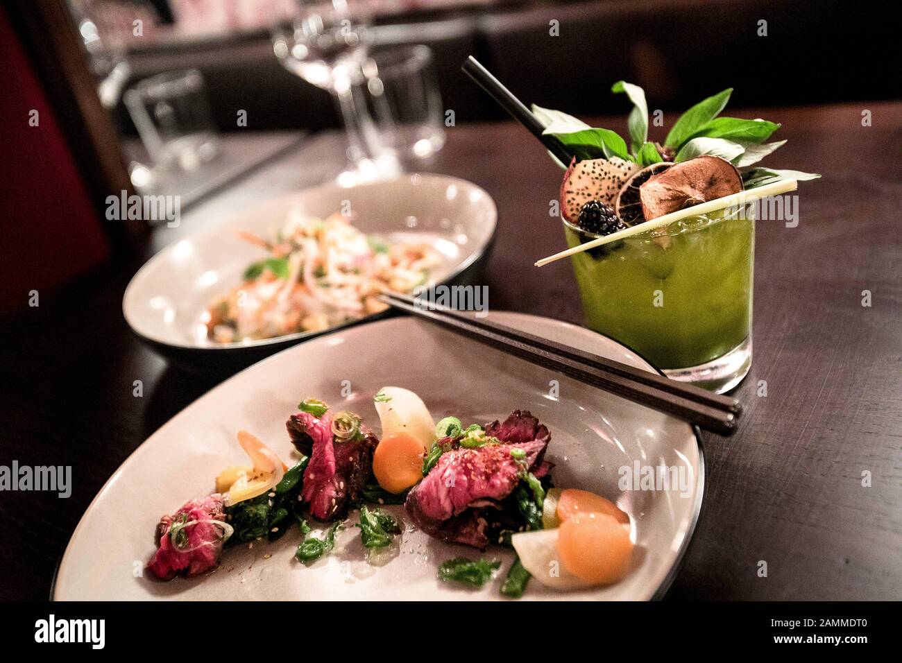Plate of hanging tender steak (front) and crayfish (back) and a ThaiBasil Smash in the Laotian