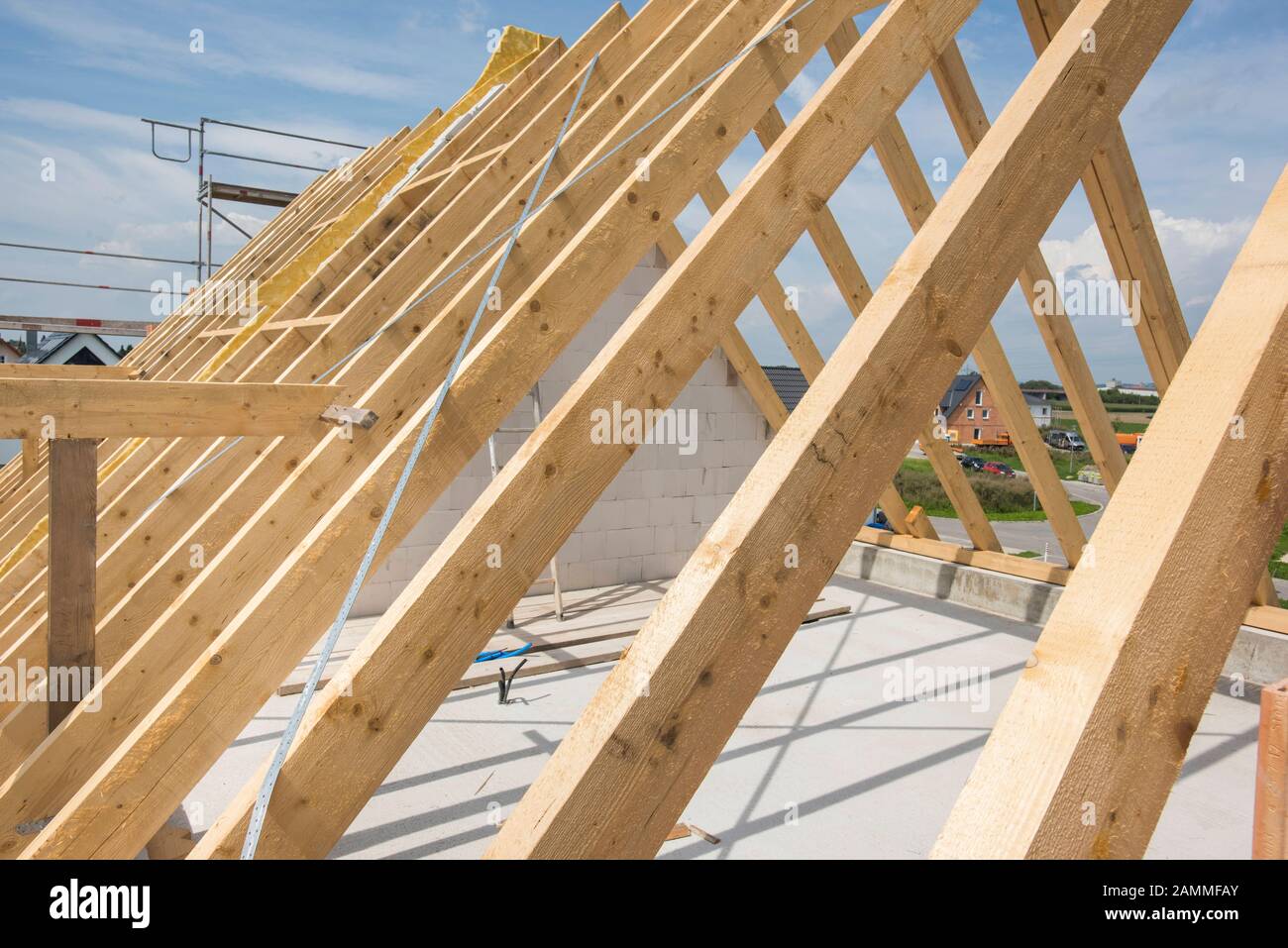 House building in shell with wooden beams in the roof truss [automated translation] Stock Photo
