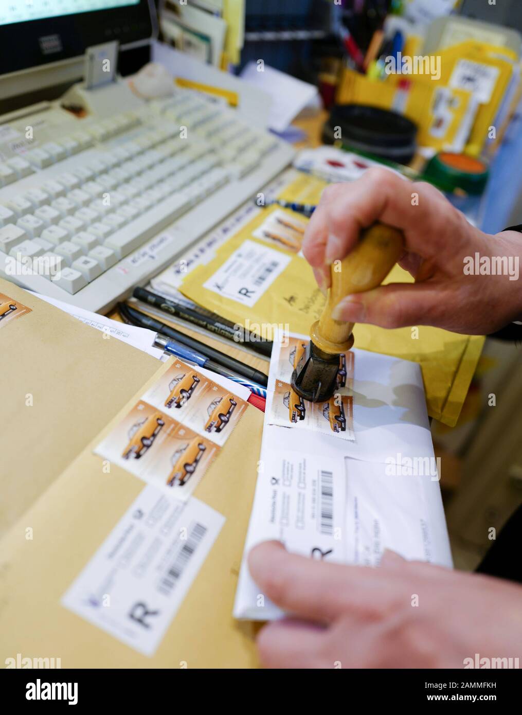 An employee stamps a letter in Rita Koerver's stationery shop in the