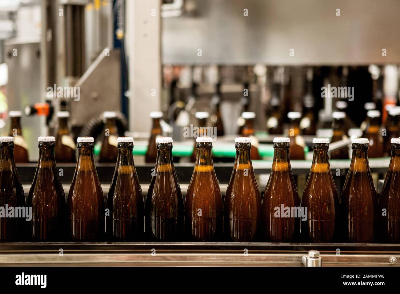 Paulaner ceremoniously commissions the first bottling line in the new brewery building in Langwied. The picture shows beer bottles on the assembly line in the bottling hall. [automated translation] Stock Photo