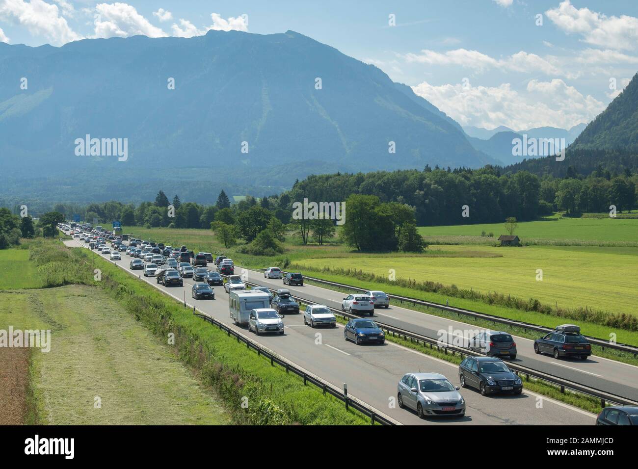 heavy to slow-moving traffic on the A8 motorway in both directions with the Untersberg in the background - designated as the gateway to Berchtesgadener Land View towards Salzburg and towards Munich [automated translation] Stock Photo