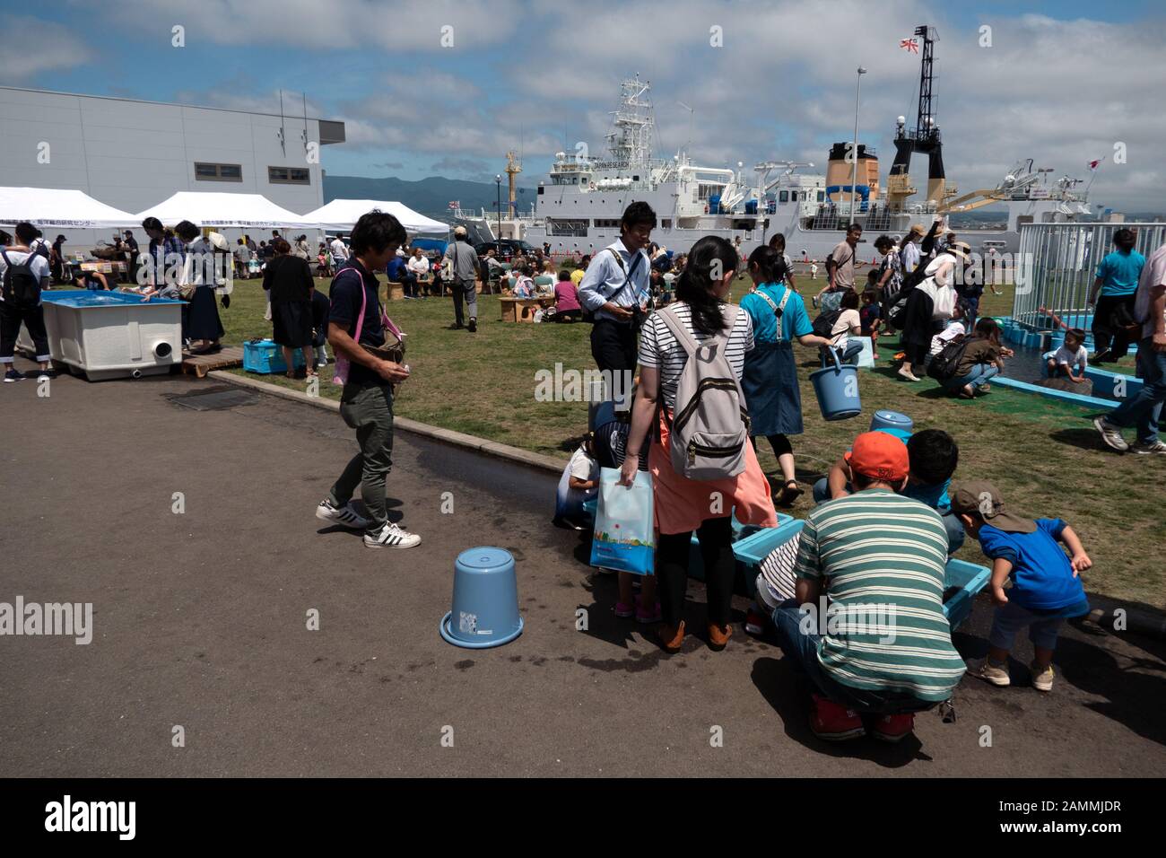 Japanese people and kids having fun and playing with sea animals at Marine Festival in Hakodate, Hokkaido, Japan, Asia Stock Photo