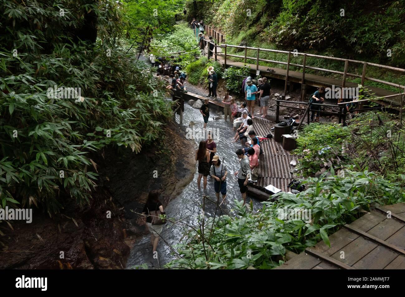 People and asian tourists enjoy river hot springs at Oyunumagawa ...