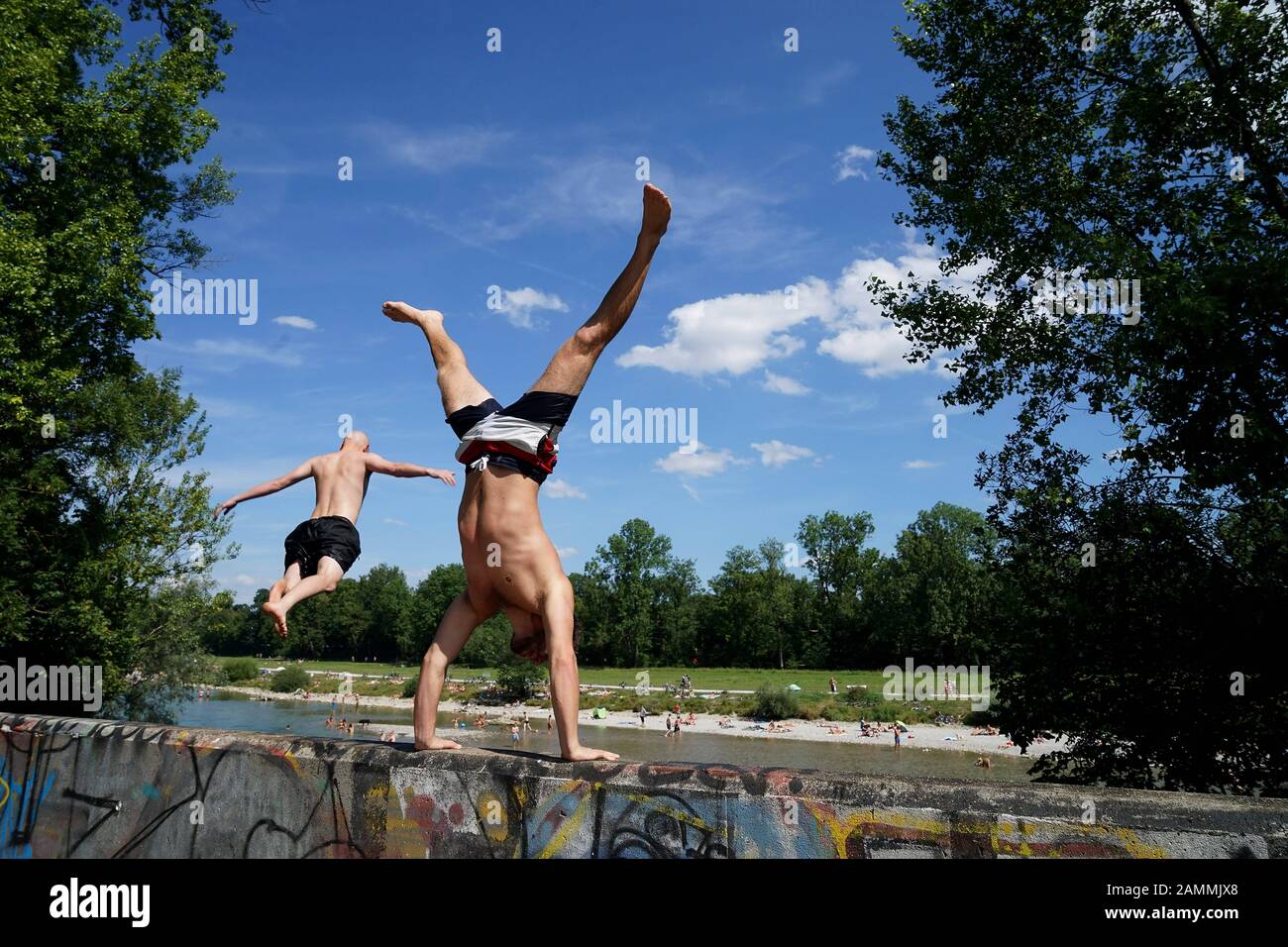 Bathers in Munich: A young man jumps from the bridge in Hefner Alteneck  Straße, near Roecklplatz, into the Isar. Special care must be taken because  the water at this point is not