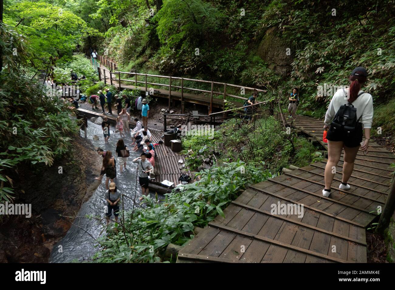 People and asian tourists enjoy river hot springs at Oyunumagawa ...