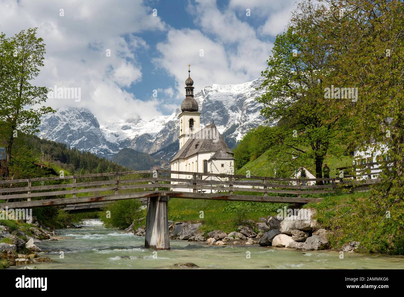the church of Ramsau - dedicated to St. Sebastian - in front of the mighty, still snow-covered massif of Reiter Alpe [automated translation] Stock Photo