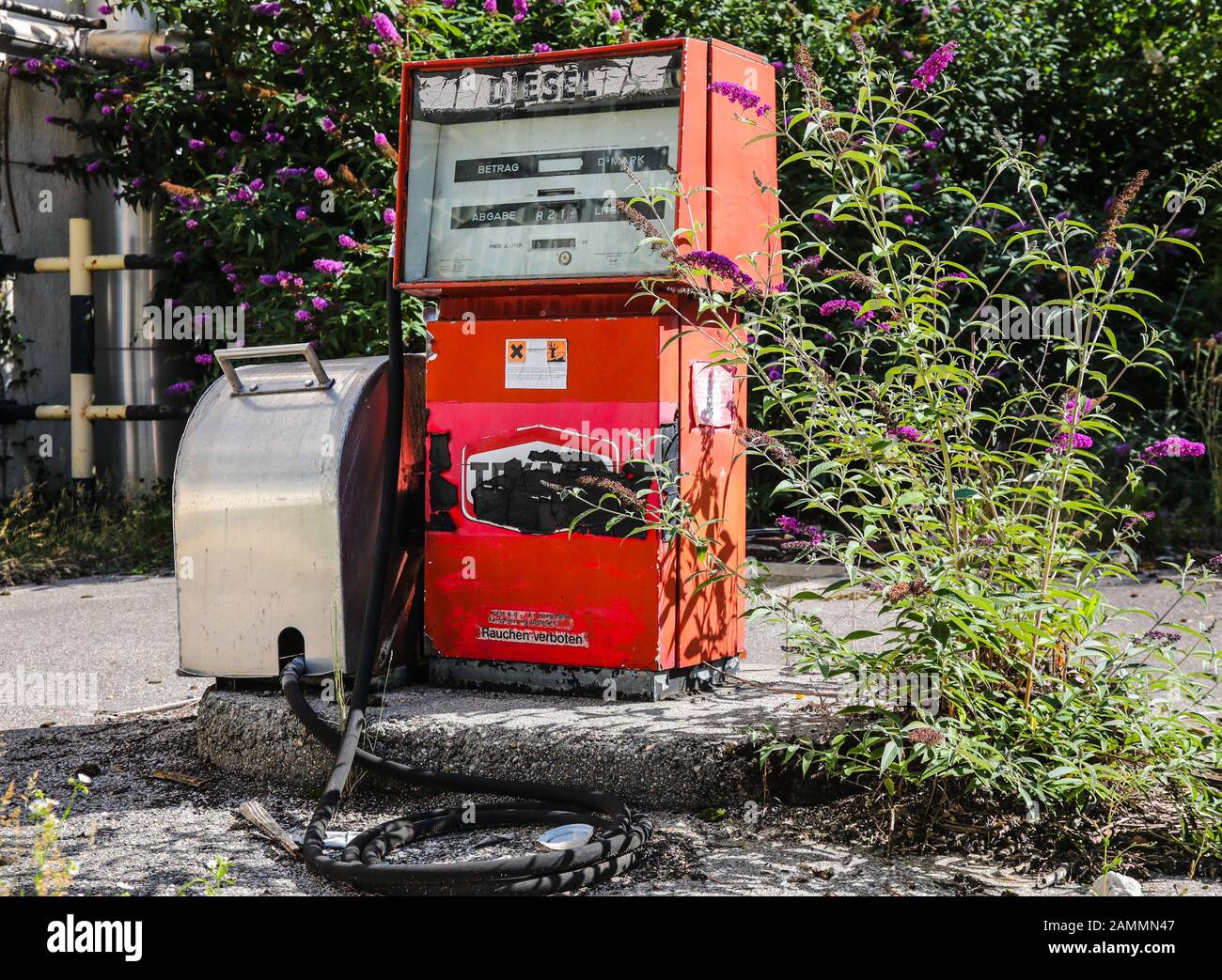 Old red petrol pump for diesel at the abandoned filling station of the MD Papierfabrik in Dachau. [automated translation] Stock Photo