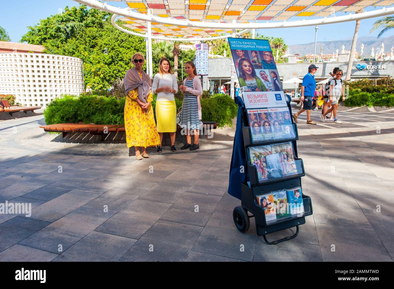 TENERIFE, SPAIN - DEC 27, 2019: Three Johovah’s witnesses women are preaching on the street with what they call cart witnessing. Stock Photo