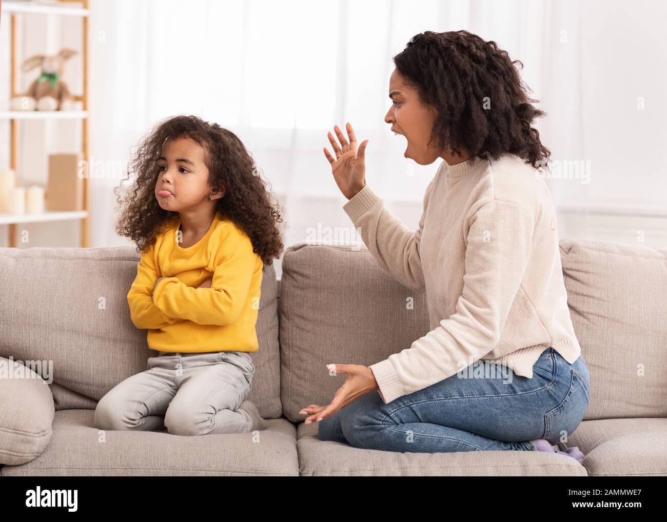 Angry Mother Shouting At Daughter Sitting On Couch At Home Stock Photo -  Alamy