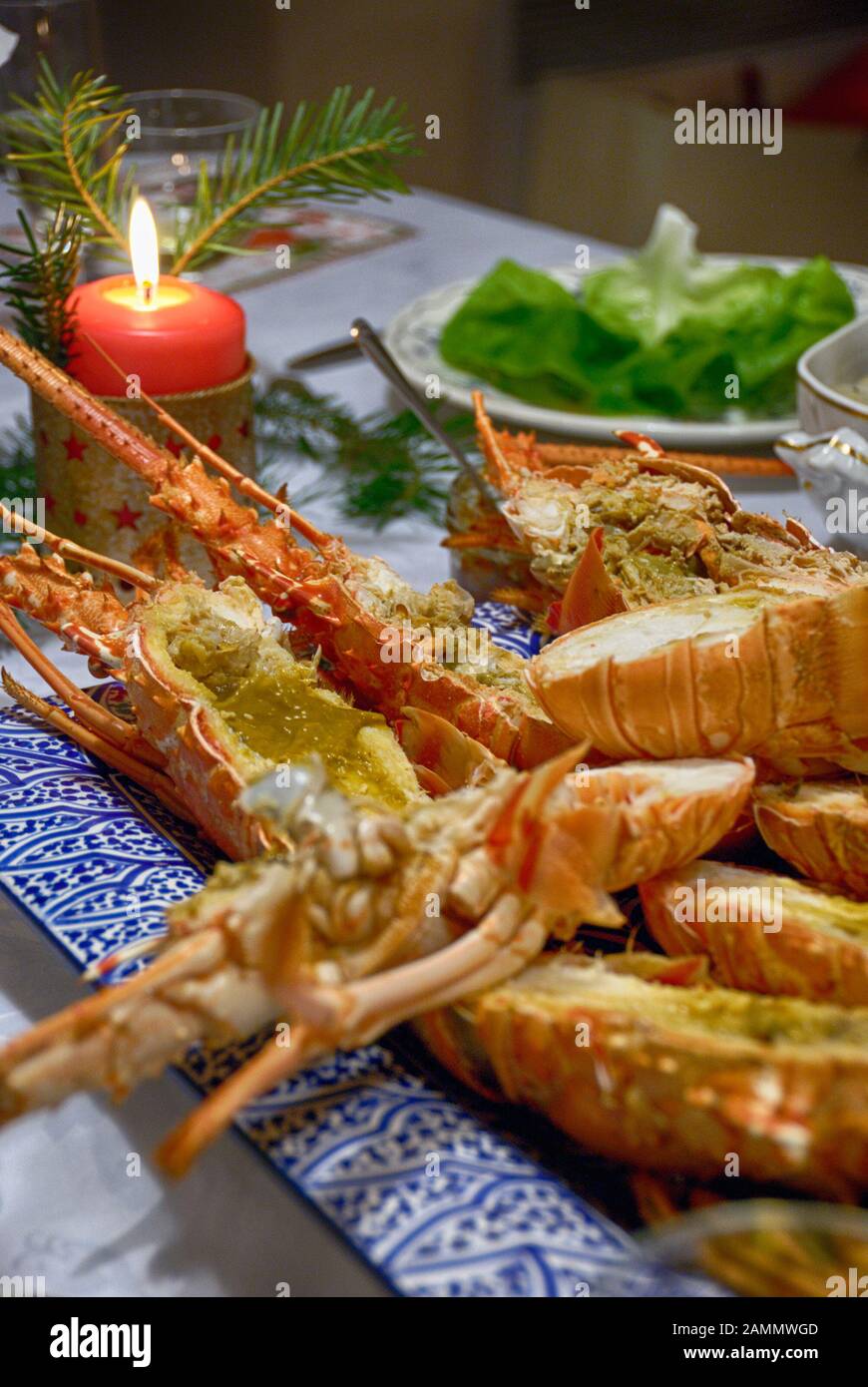 Cooked and cut lobsters on decorated dinner table Stock Photo Alamy