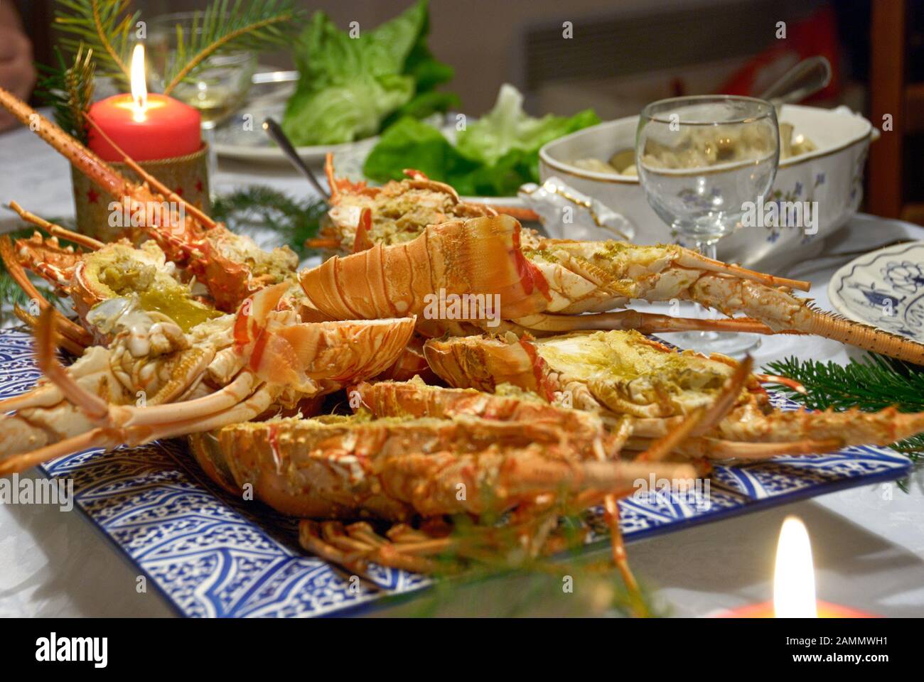 Cooked and cut lobsters on decorated dinner table Stock Photo Alamy