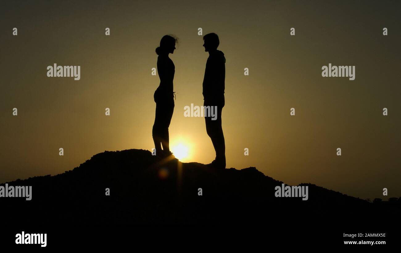 Couple standing on top hill hi-res stock photography and images - Alamy