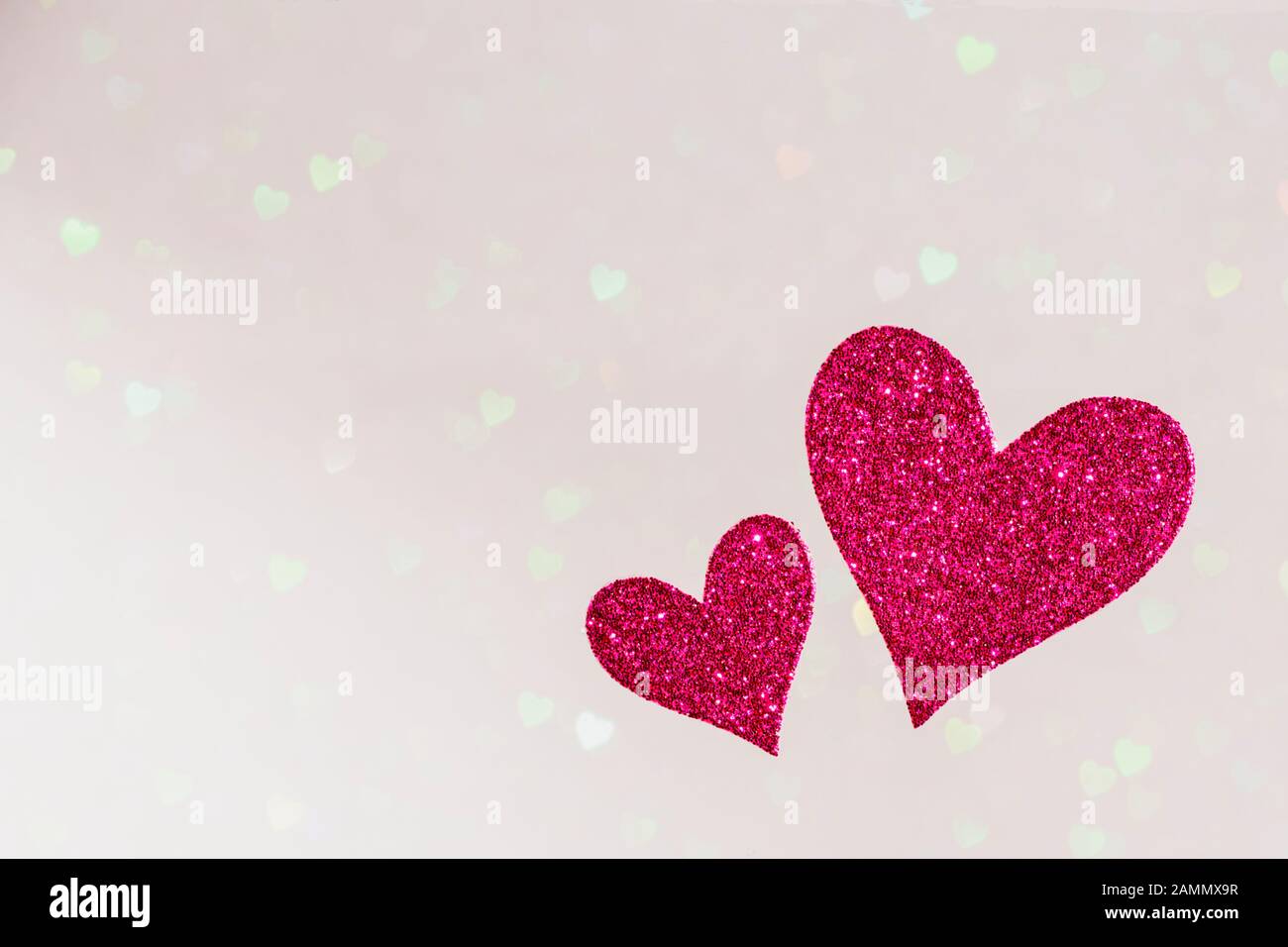 two red hearts on bright hearts bokeh background, valentines day concept design with copy space text, card template Stock Photo