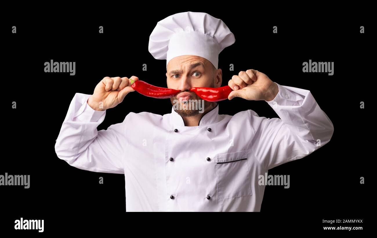 Chef Man Holding Red Peppers Like Moustaches, Black Background, Panorama Stock Photo