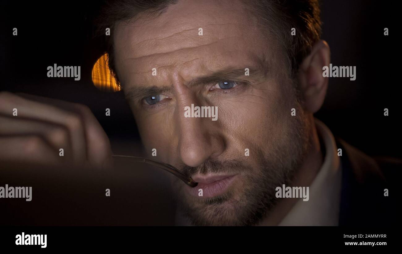 Businessman looking attentively at computer screen, thinking about report Stock Photo